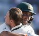 Australia's Glenn Maxwell, wearing helmet, hugs captain Steven Smith on the captain's on day one at Ranchi. 