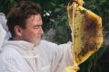 Cormac Farrell at his home in Evatt with one of the beehives he will be moving to Parliament House.