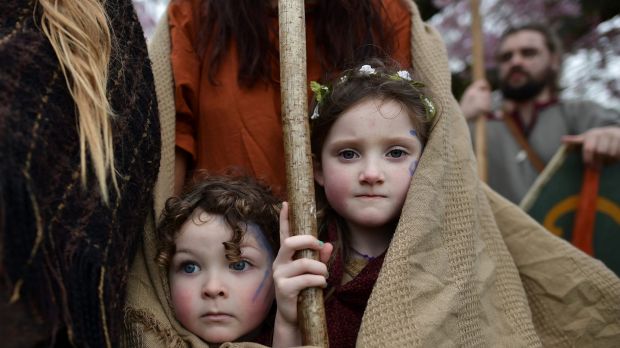 Forrest Bear Burns (L) and Willow Burns (R) huddle under their mother's shawl before they join their father, Marty Burns ...