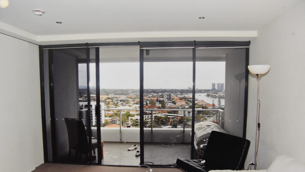 The scene of the tragedy: looking out from Tostee’s unit to the balcony where he isolated her, and the railing over which she climbed before falling to the ground.