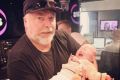 Kyle Sandilands with Michael and Kyly Clarke's baby, Kelsey Lee, last year.