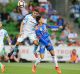 Flying high: Tim Cahill of the City heads the ball over John Koutroutmbis of the Jets for a goal.