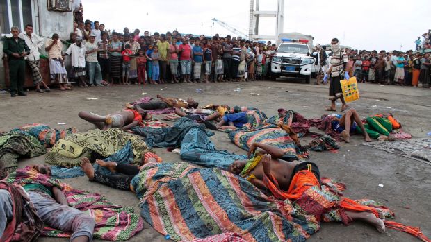 Bodies of Somalis killed in attack off the coast of Yemen lie on the ground at the Red Sea port of Hodeida, Yemen.