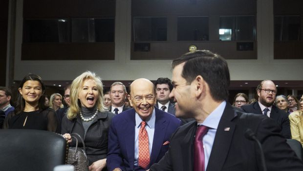 Wilbur Ross and his wife Hilary Geary smile as Senator Marco Rubio, a Republican from Florida, right, introduces Ross ...