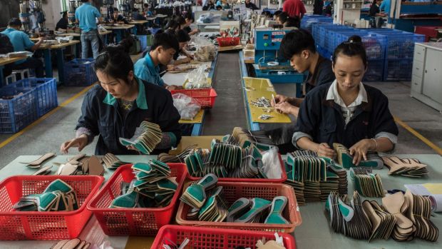 Workers on the assembly line at the Huajian shoe factory in Dongguan, China, where heels are produced for Ivanka Trump's ...