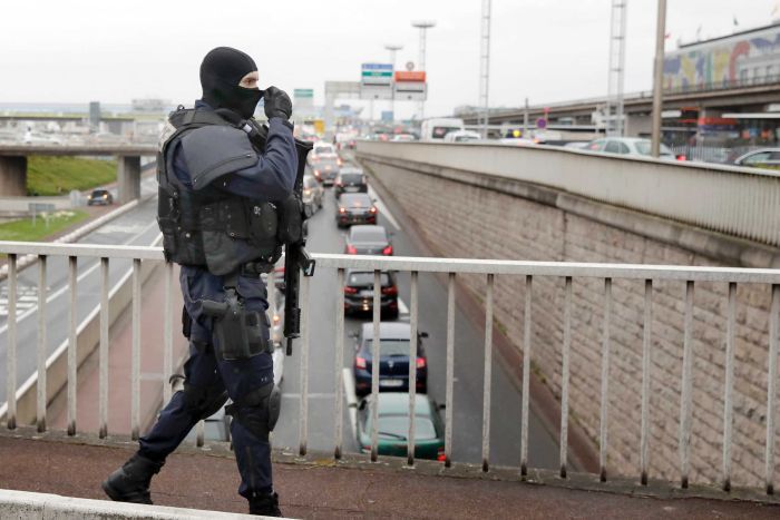 A gendarmes officer patrols the airport after the incident