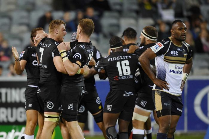 Tevita Kuridrani of the Brumbies reacts as Sharks players celebrate Lukhanyo Am's winning try. 