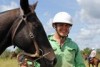 a man holding a horse