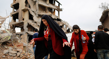  Kurdish people look at the damage to houses in south-east Cizre district in Sirnak, 3 March 2016  © EPA/CEM TURKEL