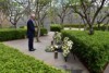 Malcolm Turnbull stands in front of wreaths.