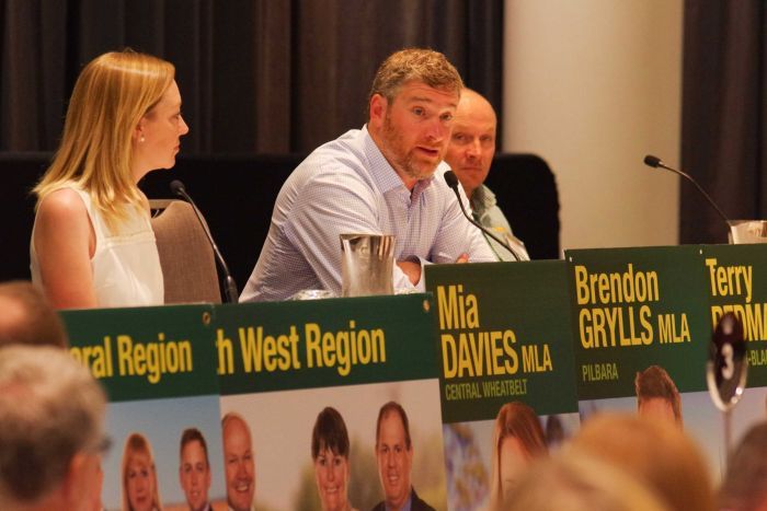 Brendon Grylls and other nationals members sit at microphone.