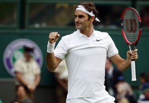 Roger Federer of Switzerland celebrates after beating Guido Pella of Argentina in their men's singles match on day one of the Wimbledon Tennis Championships in London