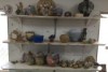 Various pots and art pieces on some shelves at Hermannsburg Pottery