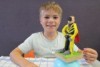 Young artist Flynn with his Shadow sculpture