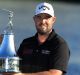 ORLANDO, FL - MARCH 19: Marc Leishman of Australia celebrates with the winner's trophy on the 18th green after the final ...