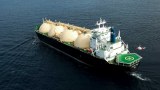 An overhead view of an LNG tanker off the WA coast with a helicopter hovering above its helipad.