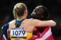LONDON, ENGLAND - AUGUST 07: Sally Pearson of Australia hugs Dawn Harper of the United States after winning the gold ...