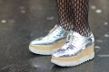 PARIS, FRANCE - MARCH 06: A guest wears silver shoes and fishnet tights, outside the Giambattista Valli show, during ...