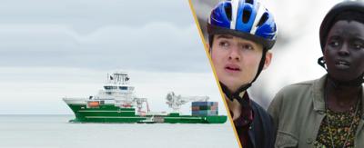 A boy and a girl looking shocked at a ship out at sea.