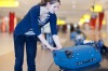 Woman picked up luggage at airport carousel.