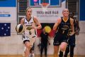 Aimie Clydesdale of Dandenong Rangers with the ball vs Sydney Uni Flames Lauren Nicholson at Brydens Staduim.