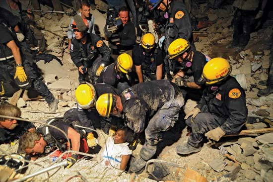 Members of the Los Angeles County Fire Department Search and Rescue Team rescuing a woman from a collapsed building in Port-au-Prince, Haiti, Jan. 17, 2010.