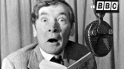 Kenneth Williams reading from a book