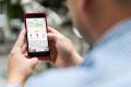 Close up of a man holding mobile phone with copy space. Westpac keyboard