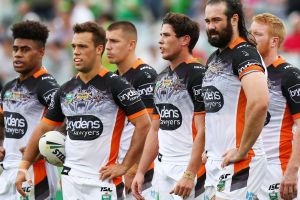 Faces tell a story: The Tigers gather behind their own try line after another Canberra try on the weekend.