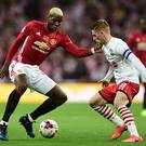 Cup battle: Steven Davis keeps an eye on United ace Paul Pogba