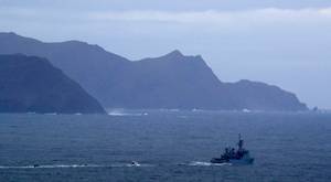 An Irish Naval ship and specialist boats near to Blacksod Lighthouse, Co. Mayo, Ireland, as the search continues for an Irish Coast Guard helicopter which went missing off the west coast of Ireland. PA