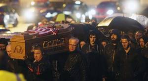 The coffin of Ryan McBride is carried aloft in Londonderry last night