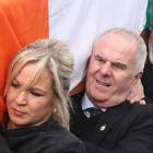 Michelle O'Neill helps carry the coffin of Mr McGuinness to his home in Londonderry