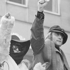 John Lennon and his wife Yoko Ono raise their fists as they join a protest in this Feb. 5, 1972, file photo in front of British Overseas Airways Corp. offices in New York on Fifth Avenue. The demonstrators called for the withdrawal of British troops from Northern Ireland.