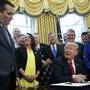 President Donald Trump jokes during a signing ceremony in the Oval Office to increase Nasa's budget (Evan Vucci/AP)