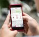 Close up of a man holding mobile phone with copy space. Westpac keyboard