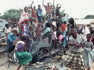 A group of young Somalis chant anti American slogans while sitting atop the burned out hulk of a U.S. Black Hawk helicopter in Mogadishu, Somalia on Oct. 19, 1993.