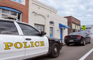 Police cars are parked in front of the Waldo Police Department in Waldo, Fla., Thursday Oct. 2, 2014.