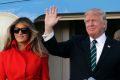 President Donald Trump waves from Air Force One with First Lady Melania and son Barron after arriving at the Palm Beach ...