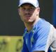 Australia's David Warner stretches during a practice session ahead of their first test cricket match against India in ...