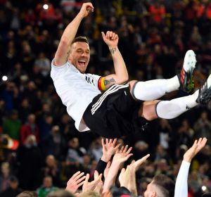 Germany's Lukas Podolski is thrown up in the air by his teammates after the friendly in Dortmund.