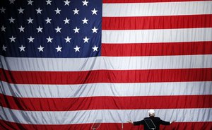 Republican presidential candidate Donald Trump turns to a large U.S. flag during a campaign rally in Sterling Heights, Mich., on Sunday, Nov. 6, 2016