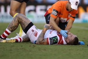 Friendly fire: The Dragons Josh Dugan receives medical attention after being his by his own teammate. 