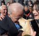 Former Vice President Joe Biden gets a kiss from a dog as he greets the crowd on Capitol Hill in Washington, Wednesday, ...