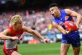 The Sydney Swans' Isaac Heeney attempts to thwart the handball-happy Bulldogs – and Jason Johannisen – in the 2016 grand ...