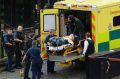 An attacker is treated by emergency services outside the Houses of Parliament in London.