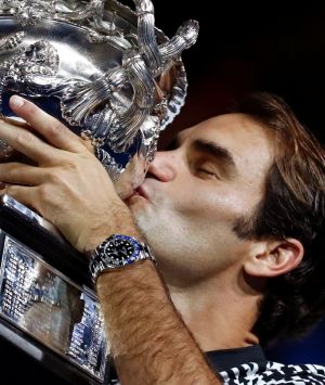 Switzerland's Roger Federer kisses his trophy after defeating Spain's Rafael Nadal during the men's singles final at the ...