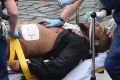 A man police have identified as Khalid Masood is treated by emergency services outside parliament. 