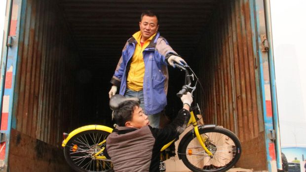 Unloading share bikes on Beijing's streets to catch the commuter rush to work.