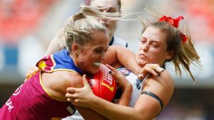 GOLD COAST, AUSTRALIA - MARCH 25: Kaitlyn Ashmore of the Lions is tackled by Georgia Bevan of the crows during the AFL ...